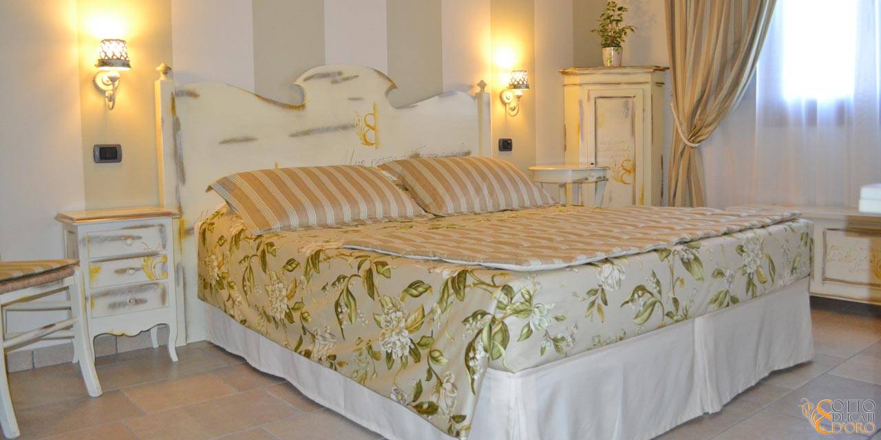 Provençal-style bedroom interiors with custom furniture at the Otto Ducati d’Oro country hotel and bed and breakfast